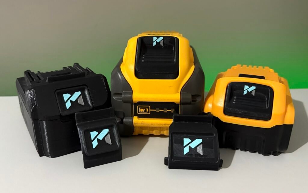 Bulk pile of power tool batteries with corporate branding tags for fleet management