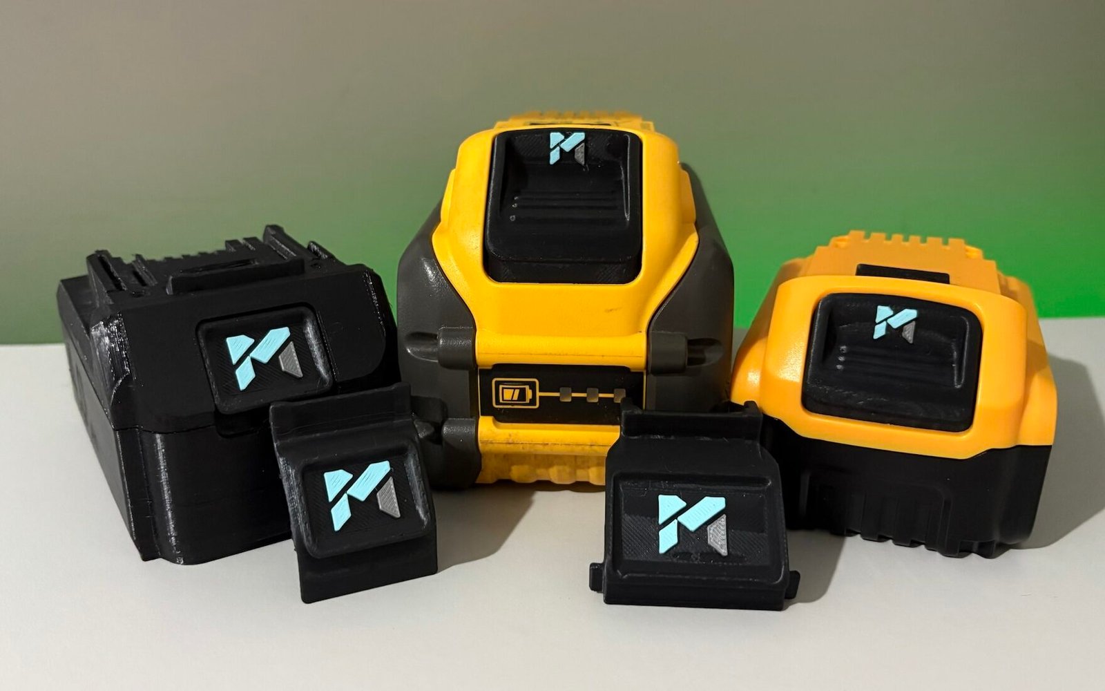 Bulk pile of power tool batteries with corporate branding tags for fleet management