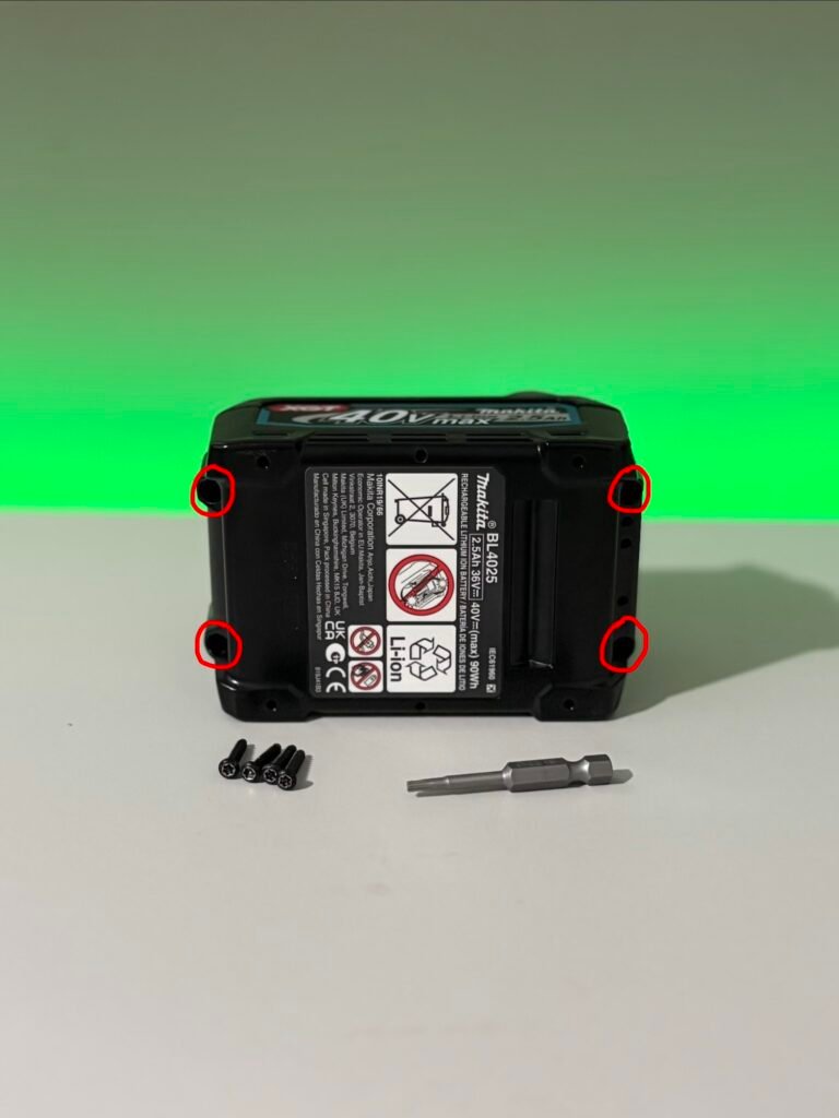 Using a T10 security bit to undo a top cover screws on a Makita 40V XGT battery before fitting a custom battery button