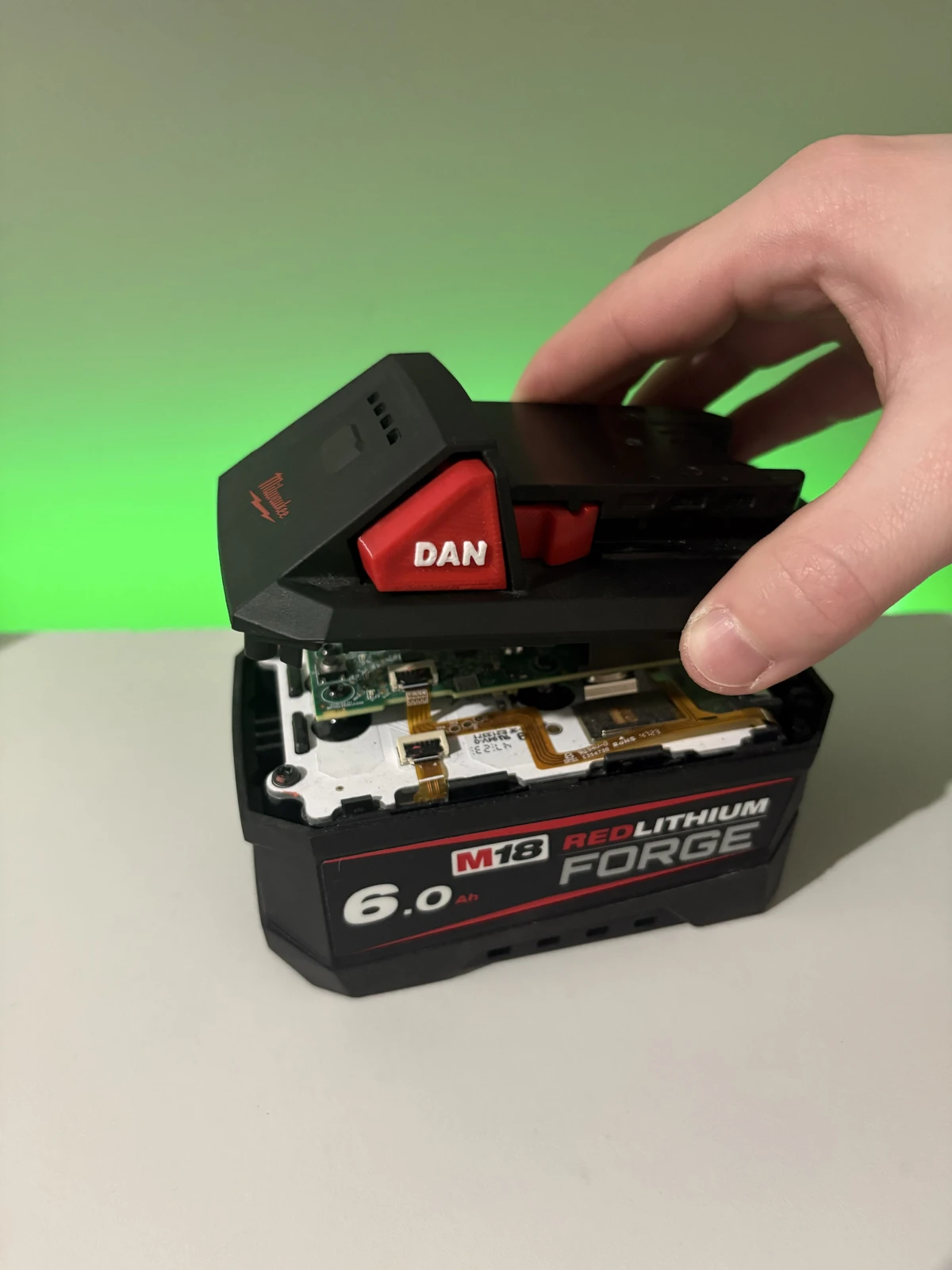 Refitting the Milwaukee M18 top casing with custom red battery release buttons